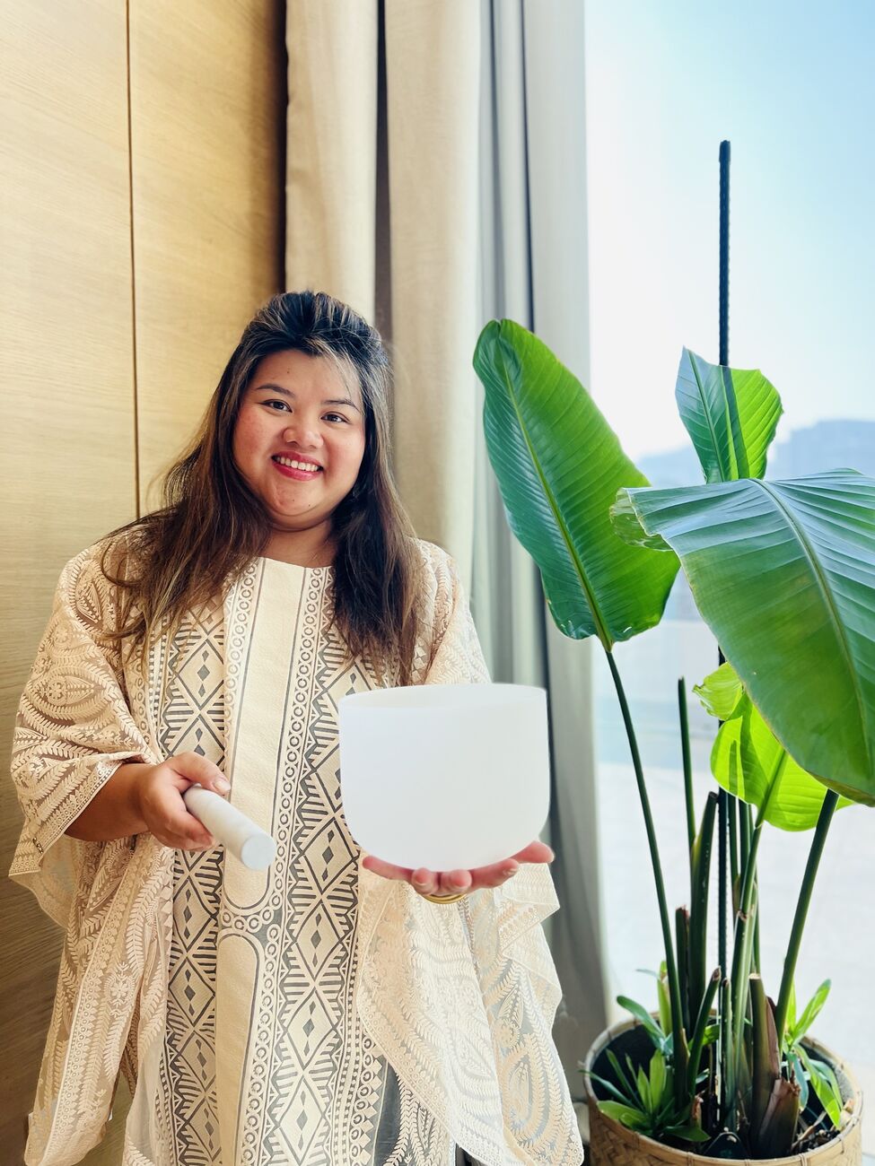 Portrait of Vivi holding a crystal singing bowl