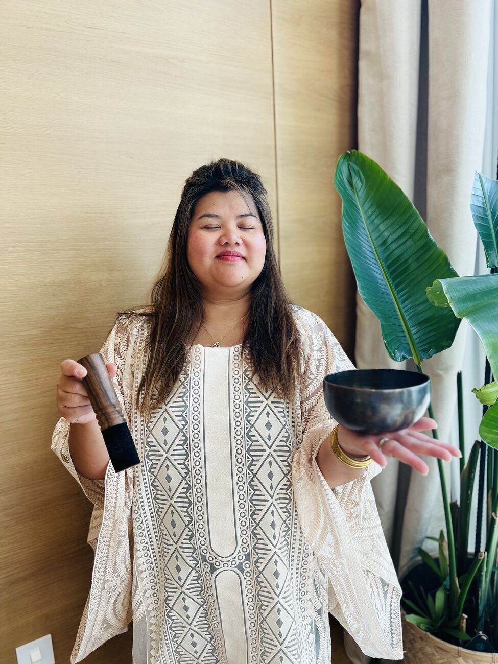 Vivi, eyes closed, holding a singing bowl
